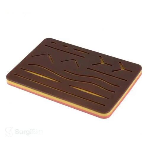 Surgical suturing training pad with engraved wound patterns